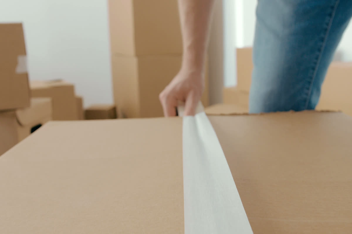 Taping a moving box shut